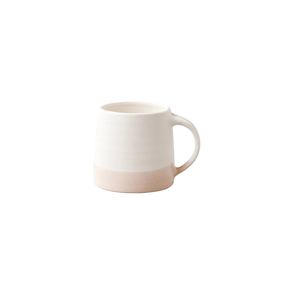 White mug with a pinkish-brown base on a white background